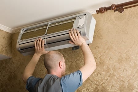 MAN DOING AIR CONDITIONING INSTALLATION
