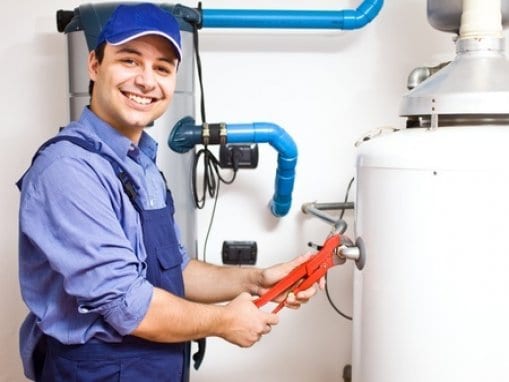 picture of man standing beside water heater installation