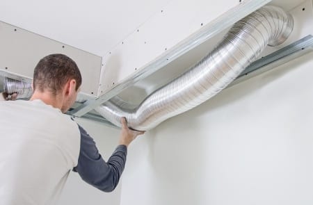 man installing ventilation duck