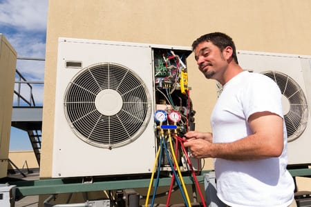 man fixing a hvac system