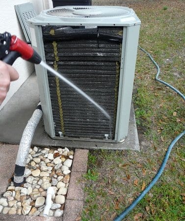Person cleaning HVAC vent - Furnace and A/C Repair in Philadelphia
