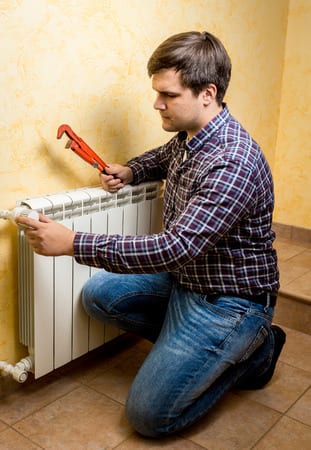 picture of plumber installing radiator