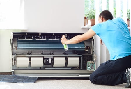 Man spraying a a/c vent 