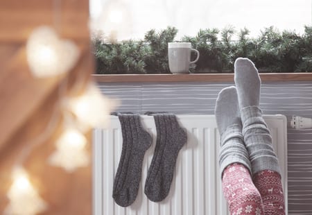 warming up by a house radiator 