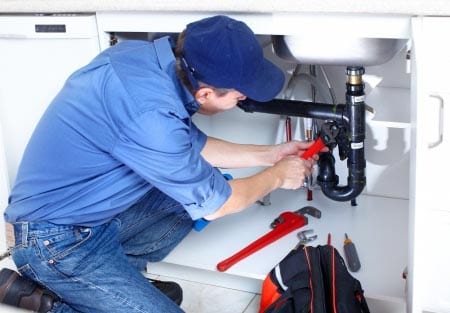 picture of man doing plumbing repair